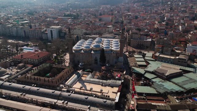 Aerial drone view of the historic Grand Mosque (Ulu Camii) and traditional bazaar district in Bursa, Turkey.