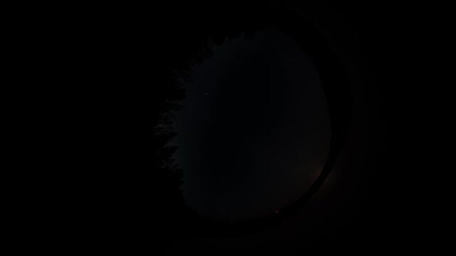 Night sky timelapse in fisheye lens view, 360 degree circular perspective of moving clouds and stars over dark forest at dusk, celestial abstract background