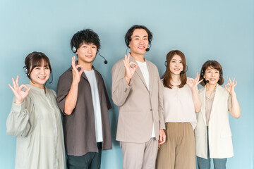 Fototapeta premium Male and female staff wearing intercoms and headsets working at call centers and customer service centers.