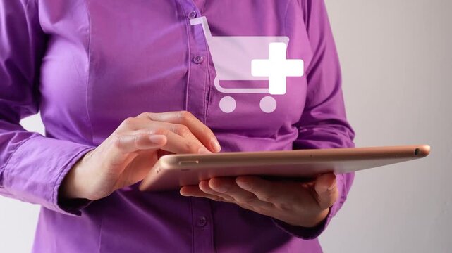 Close-up of a businesswoman interacting with her tablet and an animation of the shopping icon with the "add" button. Add more products to your cart.