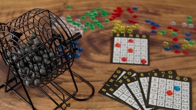 Bingo game with boards and colorful chips, camera movement from left to right