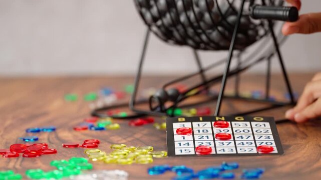 Bingo game, spinning roulette wheel, colored chips and a game board, camera movement forward