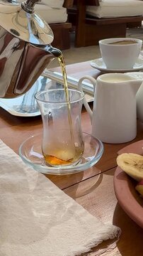 Royal Arabian all-inclusive breakfast with smoked salmon, cheese platter, basturma, fresh fruits and pastries. Elegant morning dining at a luxury resort terrace during a sunny summer vacation.