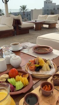Royal Arabian all-inclusive breakfast with smoked salmon, cheese platter, basturma, fresh fruits and pastries. Elegant morning dining at a luxury resort terrace during a sunny summer vacation.
