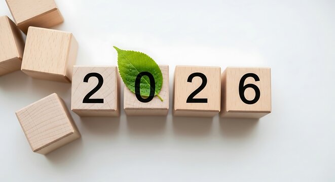 New Year 2026 with green leaf on wooden blocks