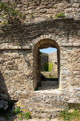 Obraz premium Wall with an arched door in the ruins of Fortress Bar, in Stari Bar, Montenegro