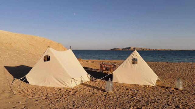  Two White Camping Tents on Sandy Desert Dune on the beach