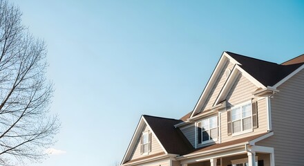 A large beige house with a dark roof and white trim