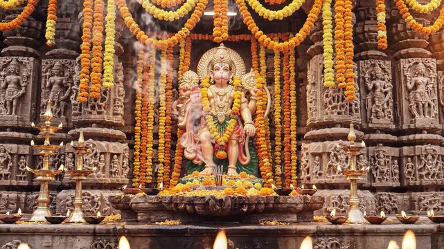 Lord Hanuman Statue with Marigold Garlands and Traditional Oil Lamps