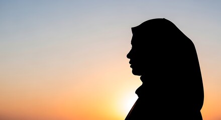 A serene silhouette of a contemplative woman in a traditional hijab, gracefully outlined against the vibrant hues of a breathtaking sunset, symbolizing peace, hope, and spiritual reflection