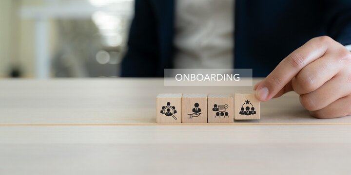 Employee Onboarding Process Concept. Business onboarding concept with wooden blocks showing recruitment, support, training and team integration icons. Employee onboarding and HR development.