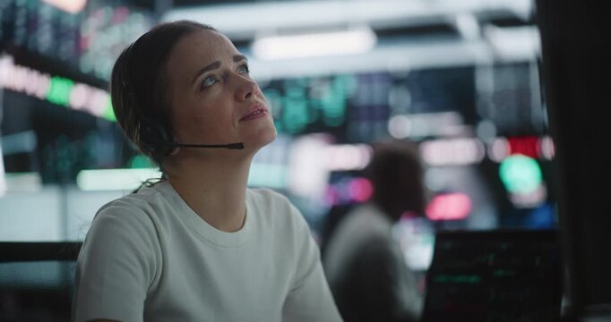 Engaged in High Stakes Financial Analysis, Professional Woman Trader Spots Significant Currency on Monitor Dashboard. Female Quickly Uses Corporate Landline Phone Relay Critical Volatility Updates.