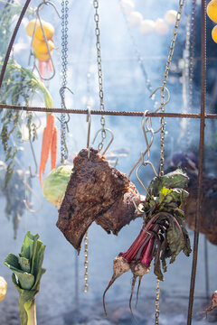 Hanging meat and vegetables over an open fire, the Australian bush cooking style. 