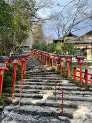Traditional stone steps with red lanterns at Japanese shrine in Kyoto