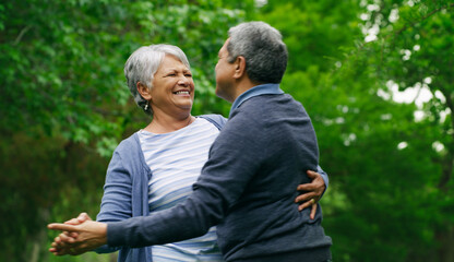Fototapeta premium Dancing, outdoor and senior couple with love, bonding together for relationship and anniversary. Nature, pensioner and old man with woman, funny and romance for marriage and celebration in Brazil