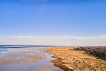 Nature, coast and empty beach with ocean for environment, ecosystem and terrain with space. Natural, background and view of sea, waves and sand for travel destination, holiday or vacation in Denmark