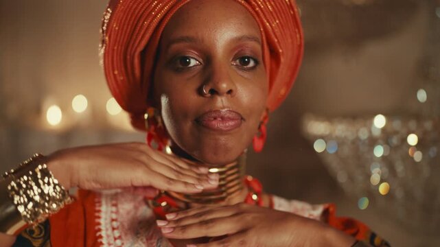 Female beauty, african ethnicity, portrait of beautiful black woman in traditional gown, vertical shot in studio. Young adult lady looking at camera, travel to africa, explore world