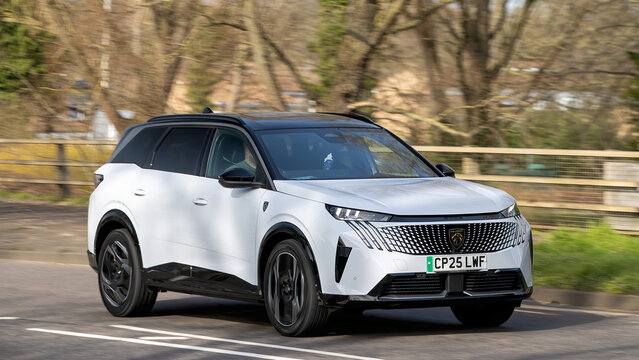 Milton Keynes,Bucks,UK - Mar 5th 2026: 2025 white Peugeot e-5008 gt electric car driving on a British road