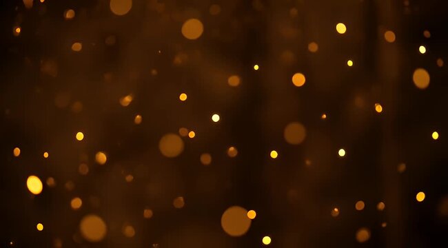 Abstract golden bokeh light effect over a dark brown gradient background
