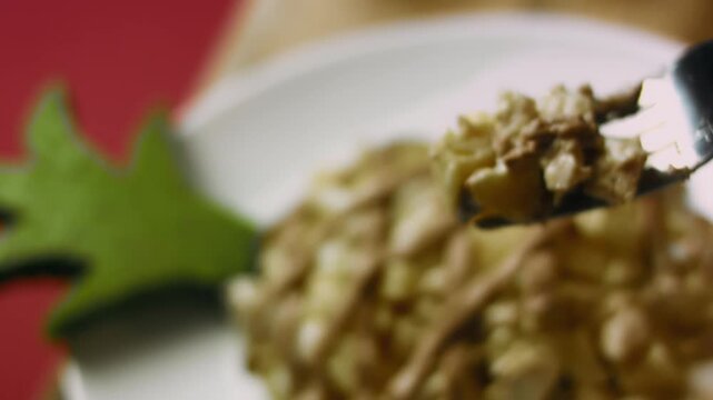 Presentation of a bite of Lady s Caprice chicken and pineapple salad on a fork