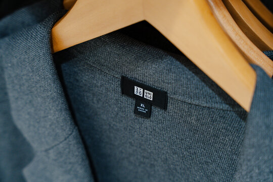 March 13, 2026, Seoul, South Korea - Close-up of a grey Uniqlo garment with an XL size label hanging on a wooden hanger