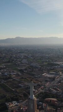 Aerial view presenting Christ of Monteagudo and Castle of Monteagudo as iconic landmarks, vertical.