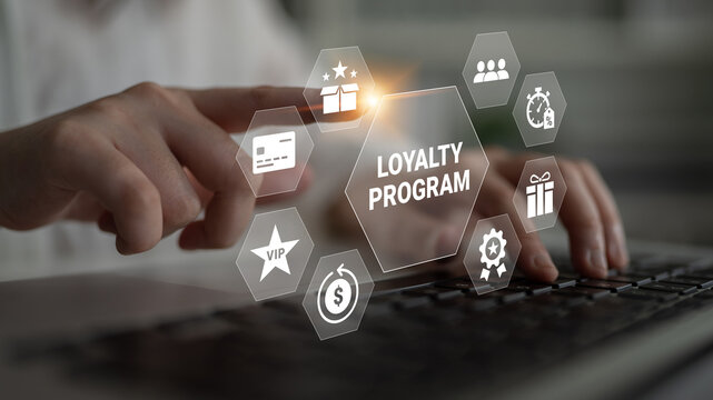 A close-up view of a person accessing a loyalty program on their laptop, showcasing various digital icons related to rewards and customer engagement strategies. Ledger