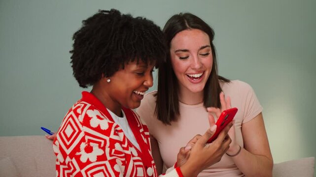 Two happy friends engaging in a warm embrace while capturing a delightful selfie together with a smartphone, showcasing their friendship and the joy of spending time with each other in a lighthearted
