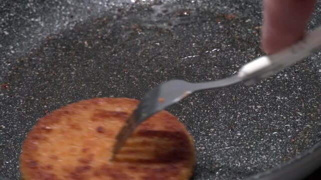 4K close up footage of frying fishburger in the pan