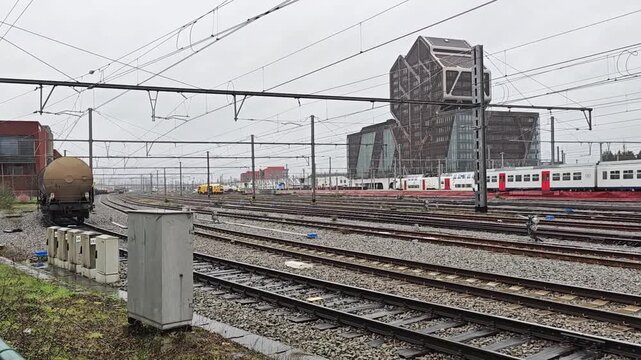 13 March 2026, Hasselt, Belgium: Freight train with VTG tank wagons passing railway yard near Hasselt courthouse