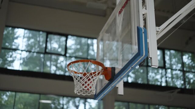 Bottom view, Basketball flying past basketball hoop