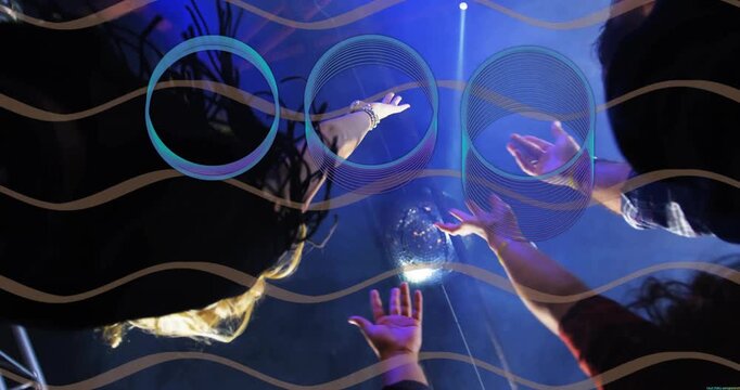 Event attendees passing mirror orb, sharing cupping and releasing while blue rings hovering above