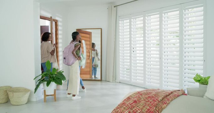 African family entering via wooden door adjusting backpacks by mirror returning home, copy space