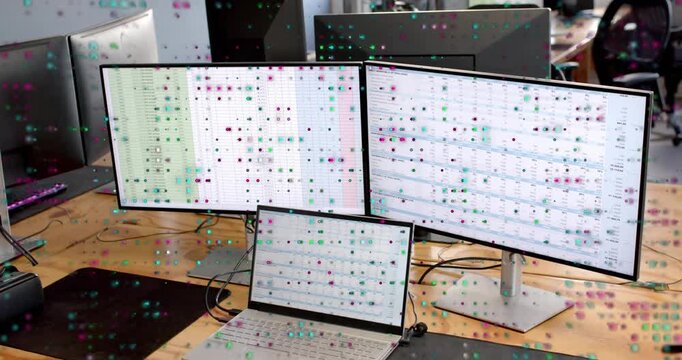 Desk starting playback dual monitors and laptop showing grid teal-magenta overlay shifting for tech