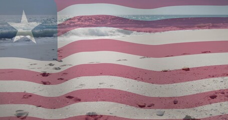 Naklejka premium Overlaying translucent American flag blending with sandy shore revealing footprints and foamy surf
