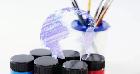 Showing six paint jars blackcap on art table, holo globe floating above blue-rim holder and brushes
