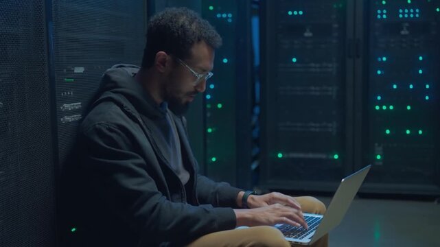 Black IT Technician Working with Server Racks in a Modern Data Center. Providing Maintenance Work and Installing New Hardware for Database and Storage Hard Drives for AI Model Training Computer