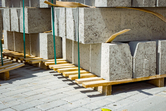 Pack of concrete curbstone stacked and tied on pallet