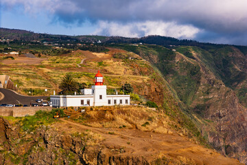 Aerial view of Farol do Ponta do Pargo lighthouse on the western cliffs of Madeira Island above the Atlantic Ocean © Leonid