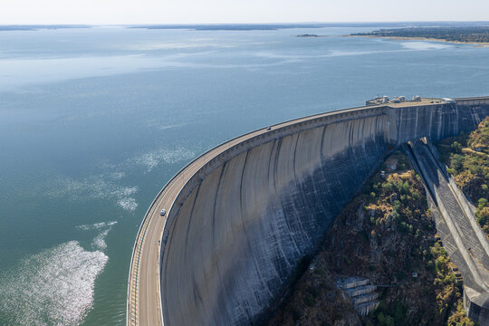 Large conrete wall of a dam with barrier lake (Presa de Almendra, Spain)