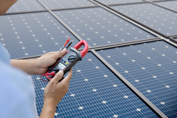 Solar energy technician testing photovoltaic system with multimeter for electrical maintenance