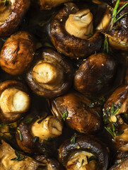 Fototapeta premium Roasted Mushrooms with Herbs and Garlic in Butter Juices, Extreme Macro Food Photography