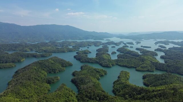 Drone flyover of Ta Dung Lake showing forested islands in Dak Nong, Central Highlands Vietnam