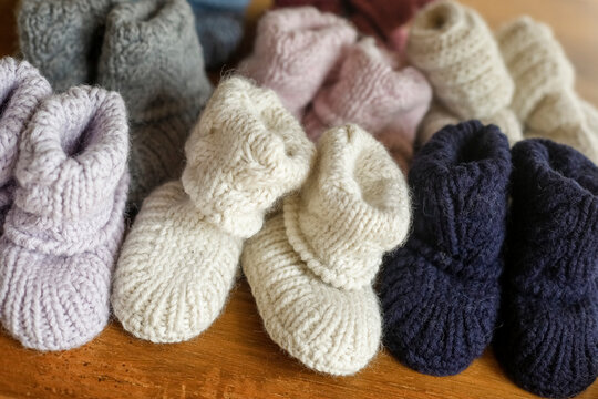 Handknit baby booties in soft neutral colors