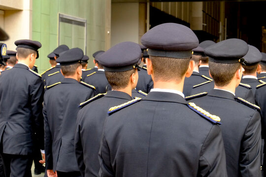 Group of uniformed cadets or officers standing together from behind