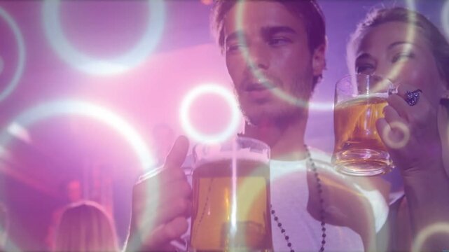 Couple drinking beer mugs and socializing at nightclub, activating animated rings overlaying scene