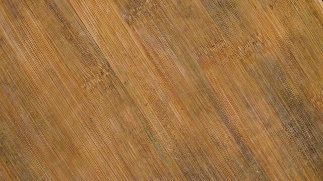 Rotating bamboo cutting board texture with natural grain and worn surface marks