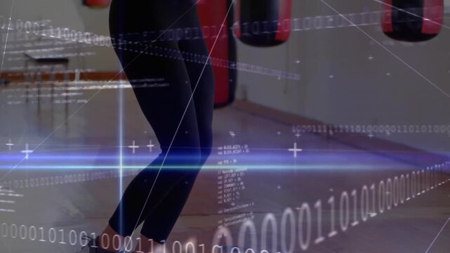 Woman starting jumping rope in gym shifting toward bags with HUD crossing over subject for boxing