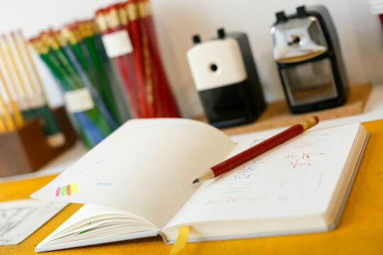 Open Notebook with Pencil and Classroom Supplies