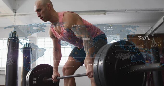 Mid-adult man gripping barbell and initiating lift by driving legs for gym strength training